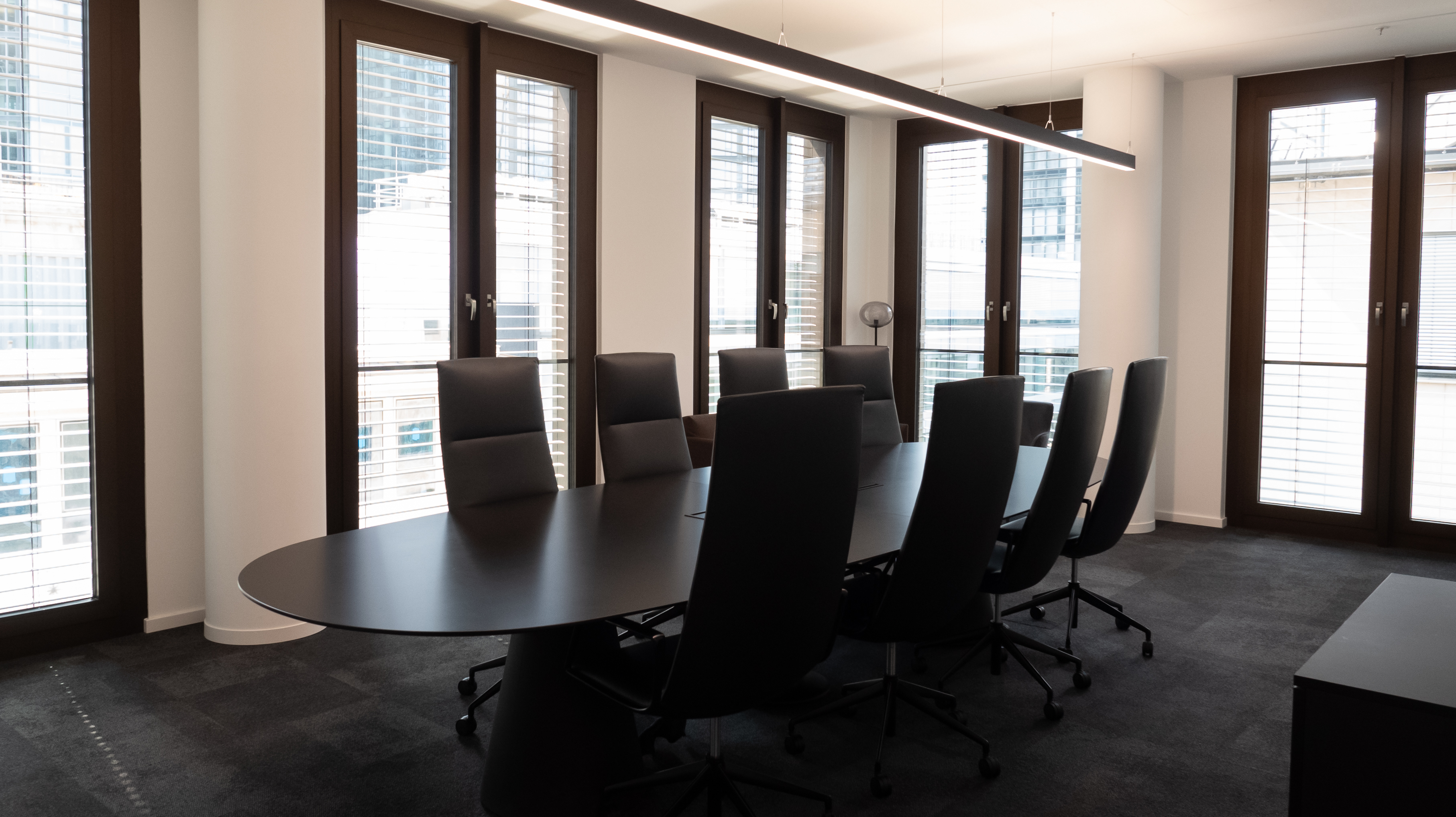 Vista — 12-seat boardroom on Floor 7 with floor-to-ceiling windows onto the Frankfurt skyline.